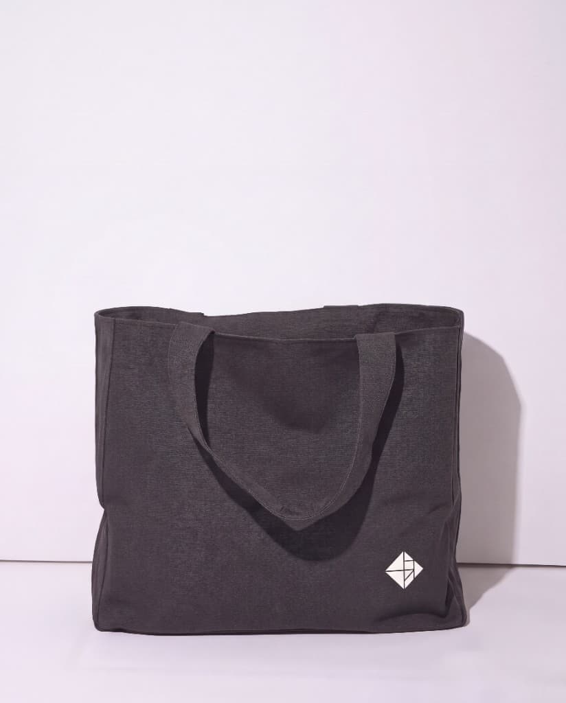Charcoal tote bag with white Pandita tangram logomark